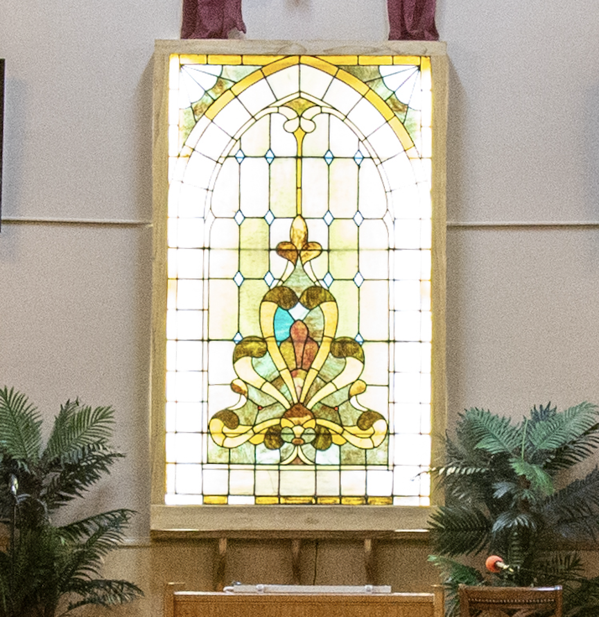 Stained glass from the early 1900's displayed above the altar in the River of Life Sanctuary